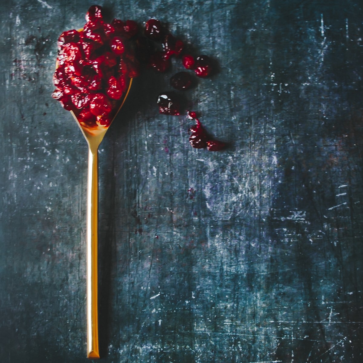 cranberries roasted on a spoon for chocolate tart with cranberries
