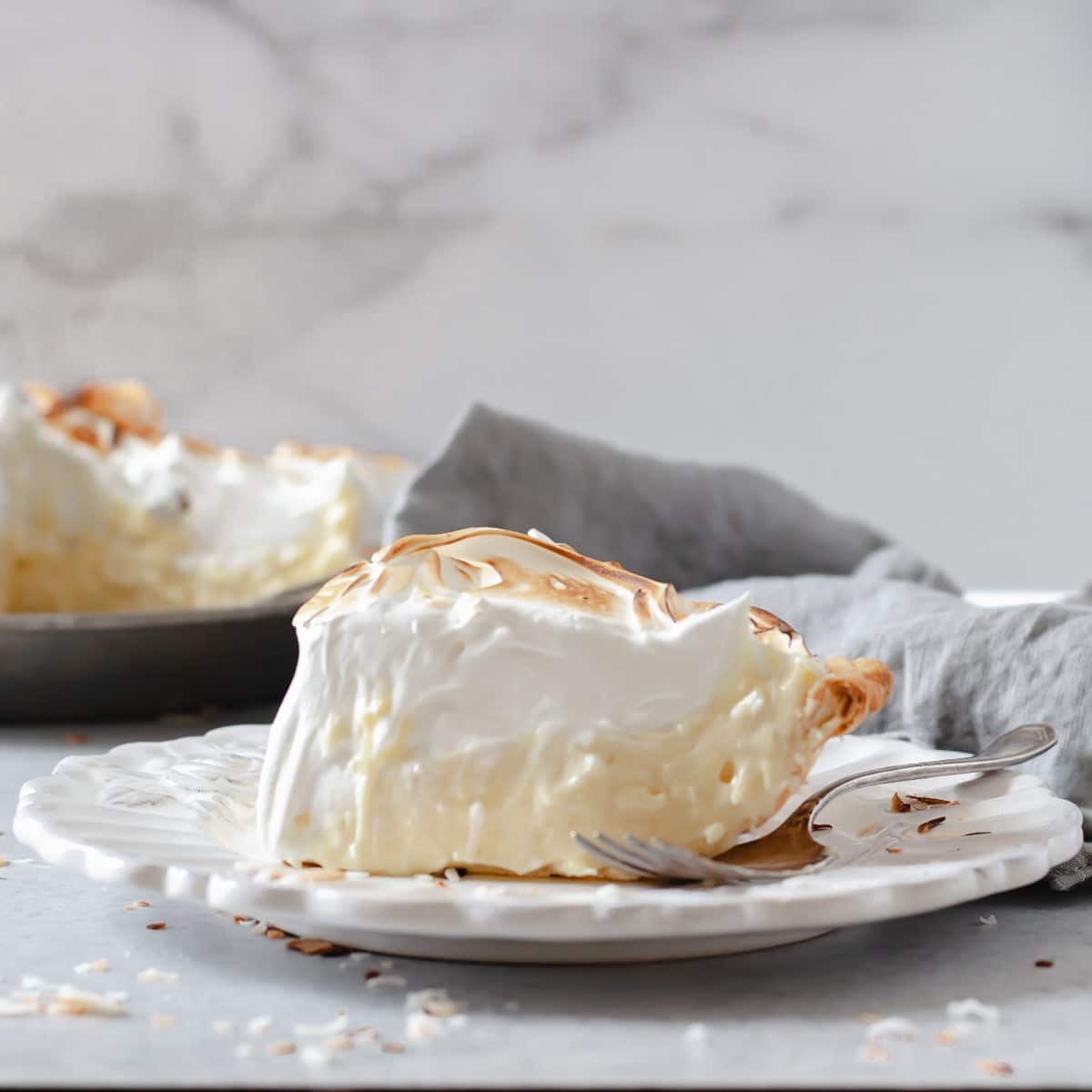 slice of old fashioned coconut cream pie with meringue