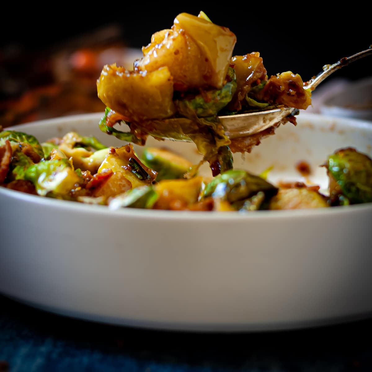 Close-up of brussel sprouts with bacon on a spoon