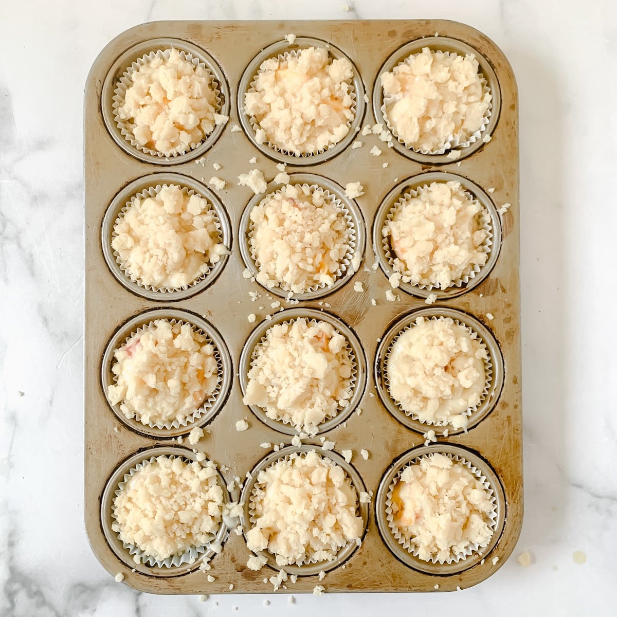 Unbaked muffins with streusel in muffin pan